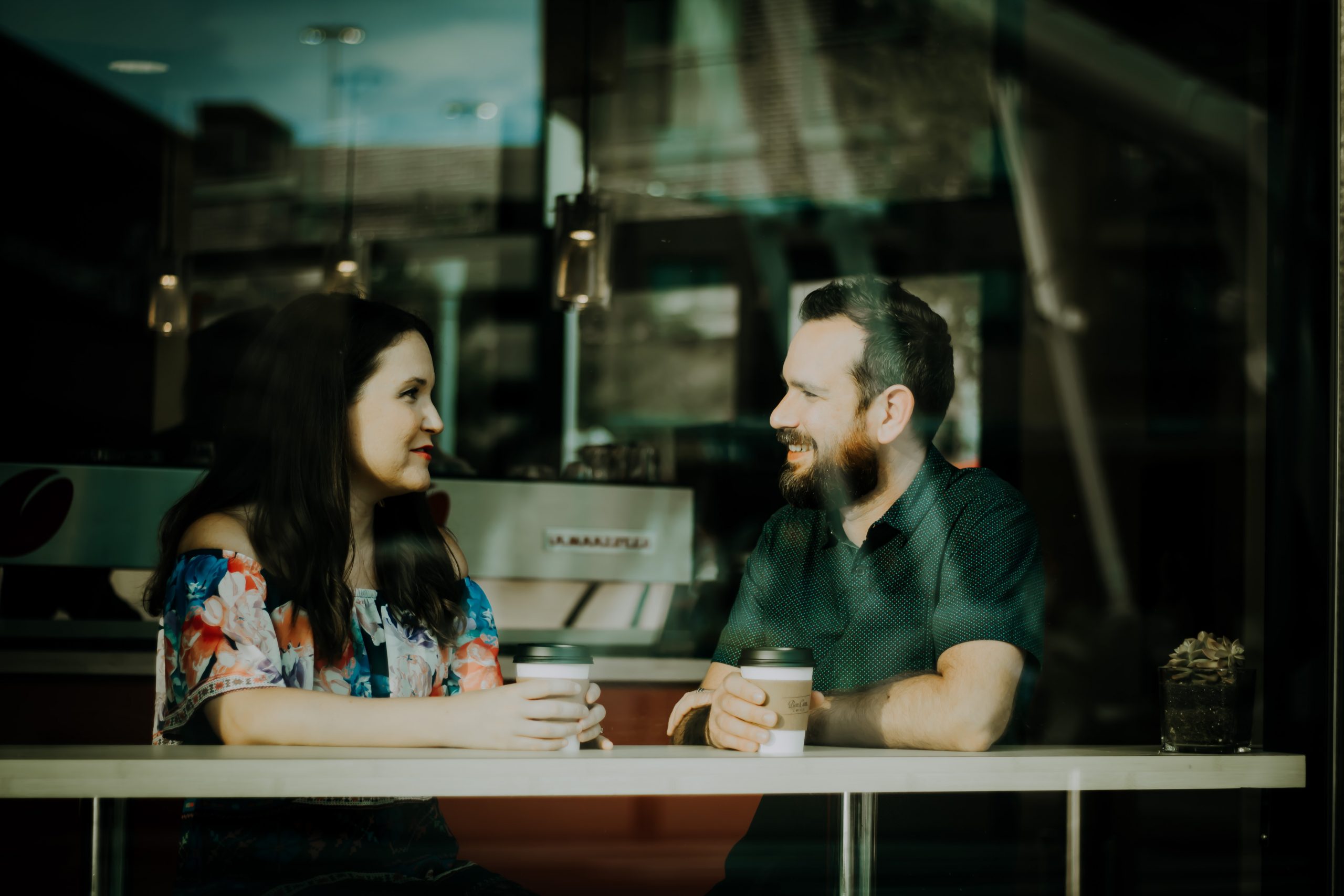 couple talking over coffee at a coffeeshop