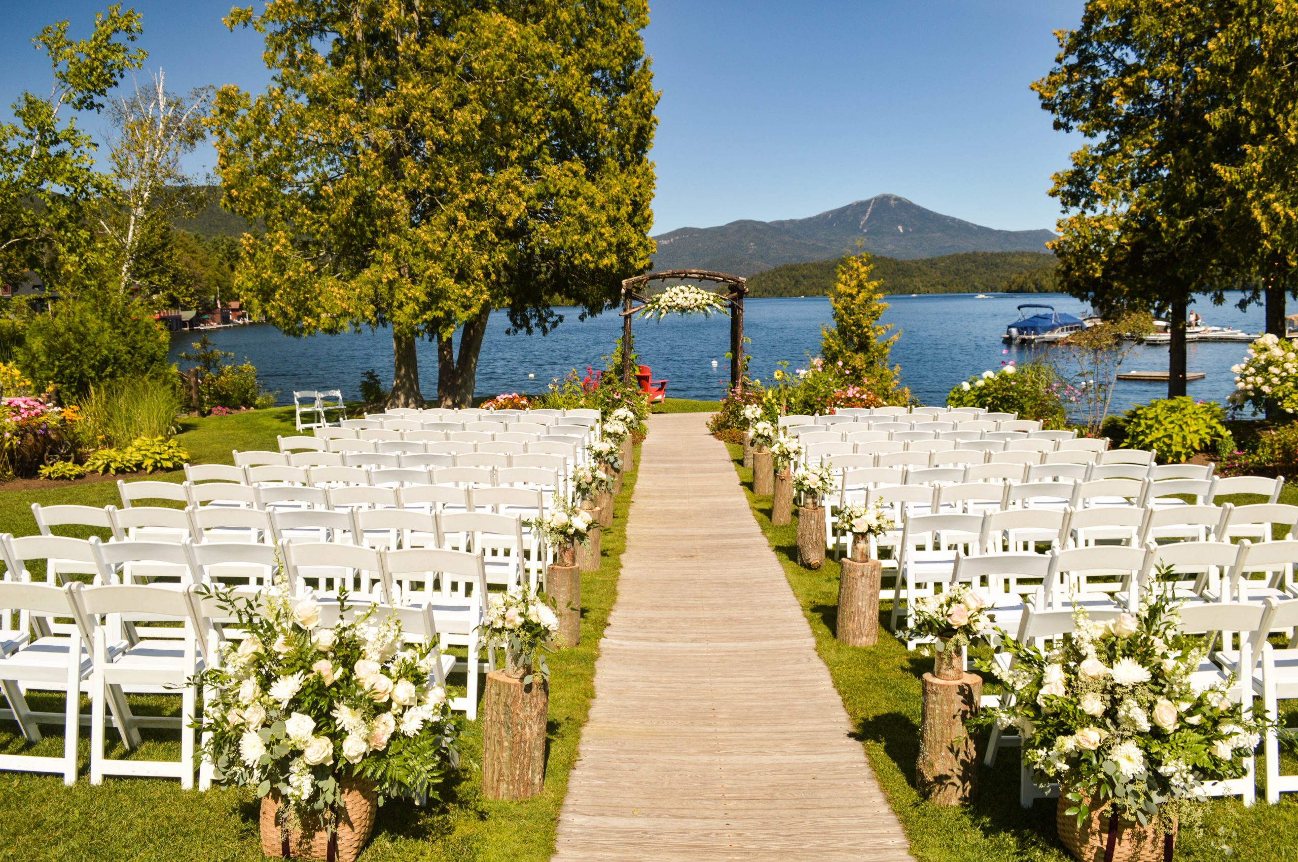 outdoor wedding venue with chairs and alter overlooking lake