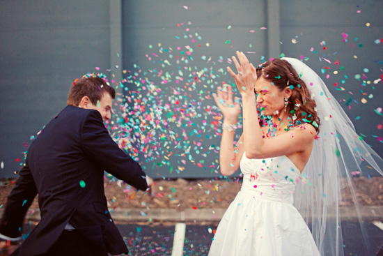 Couple posing with confetti.