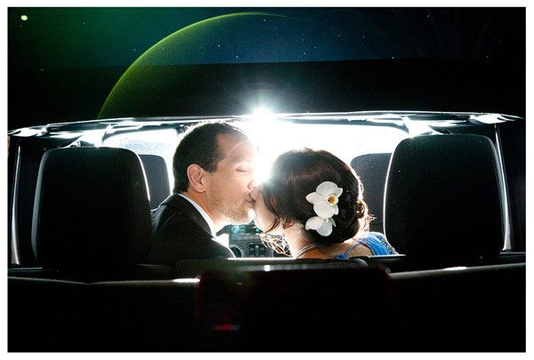 Couple kissing in the back of a limo. 