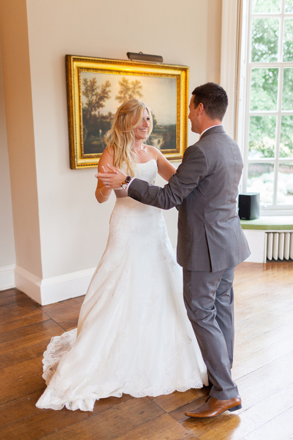 Couple dancing in a living space.