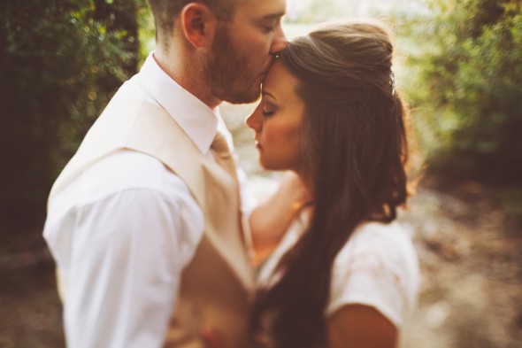 Groom kissing forward of bride.