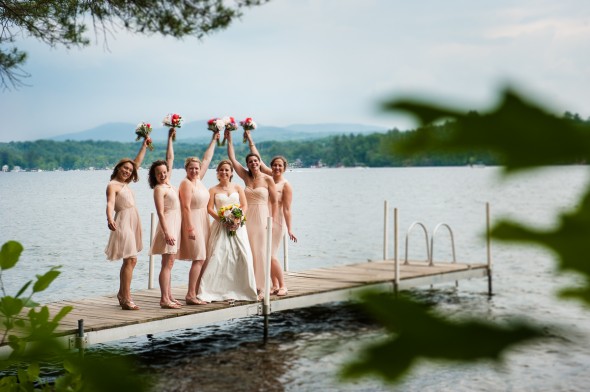 bridesmaids standing on dock with bride