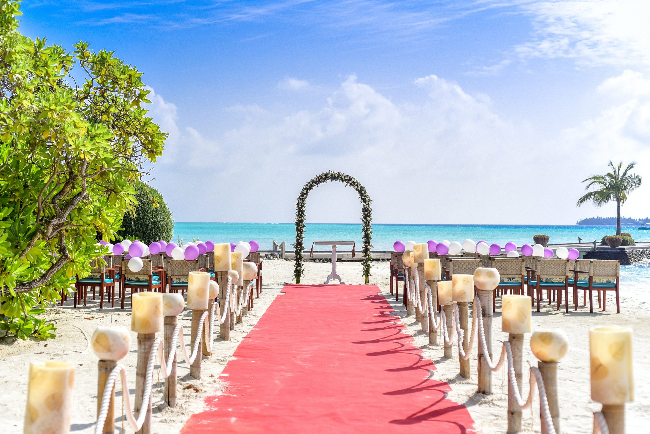 Beach wedding with aisle and seats leading out to ocean horizon.