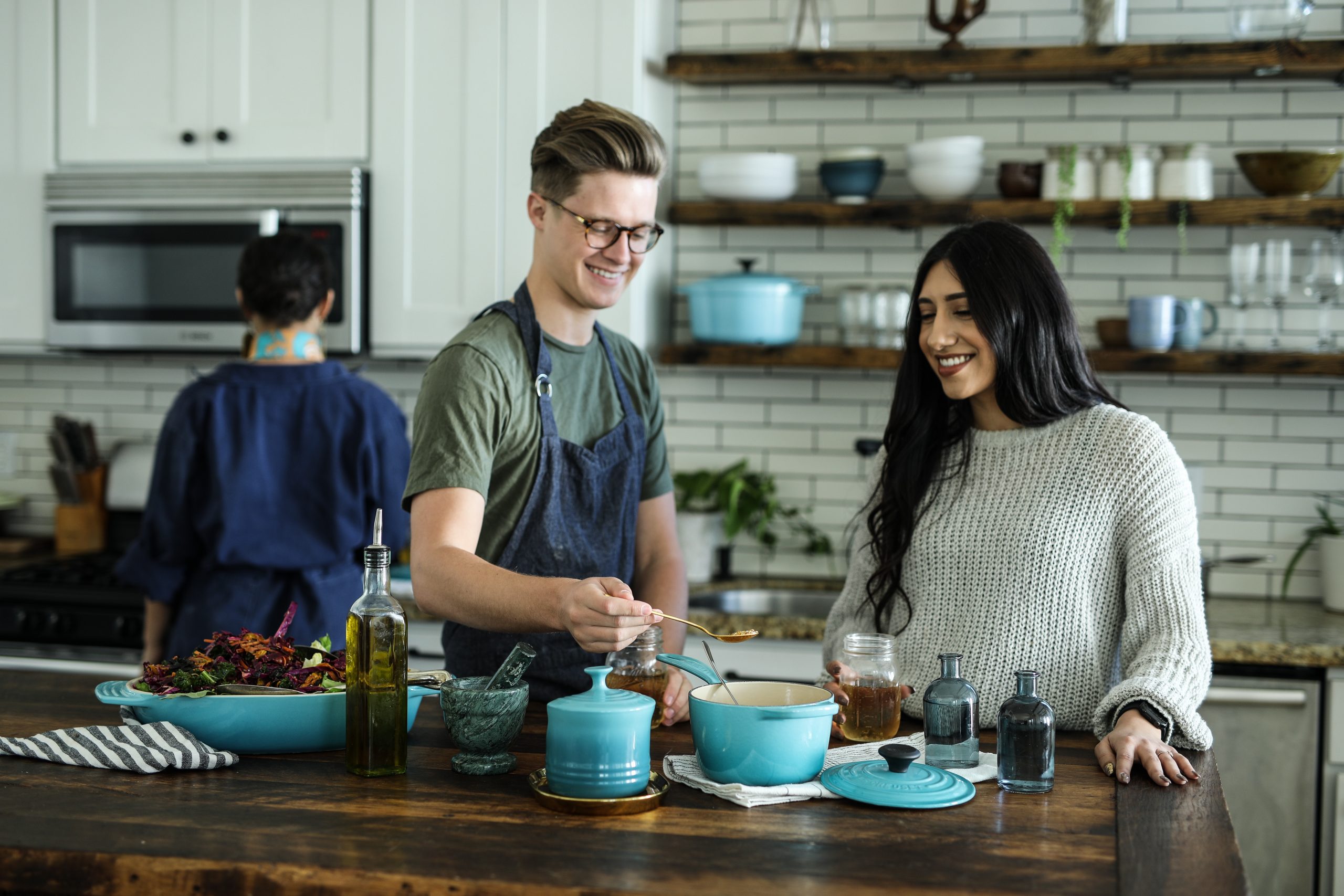couple cooking together in kitchen