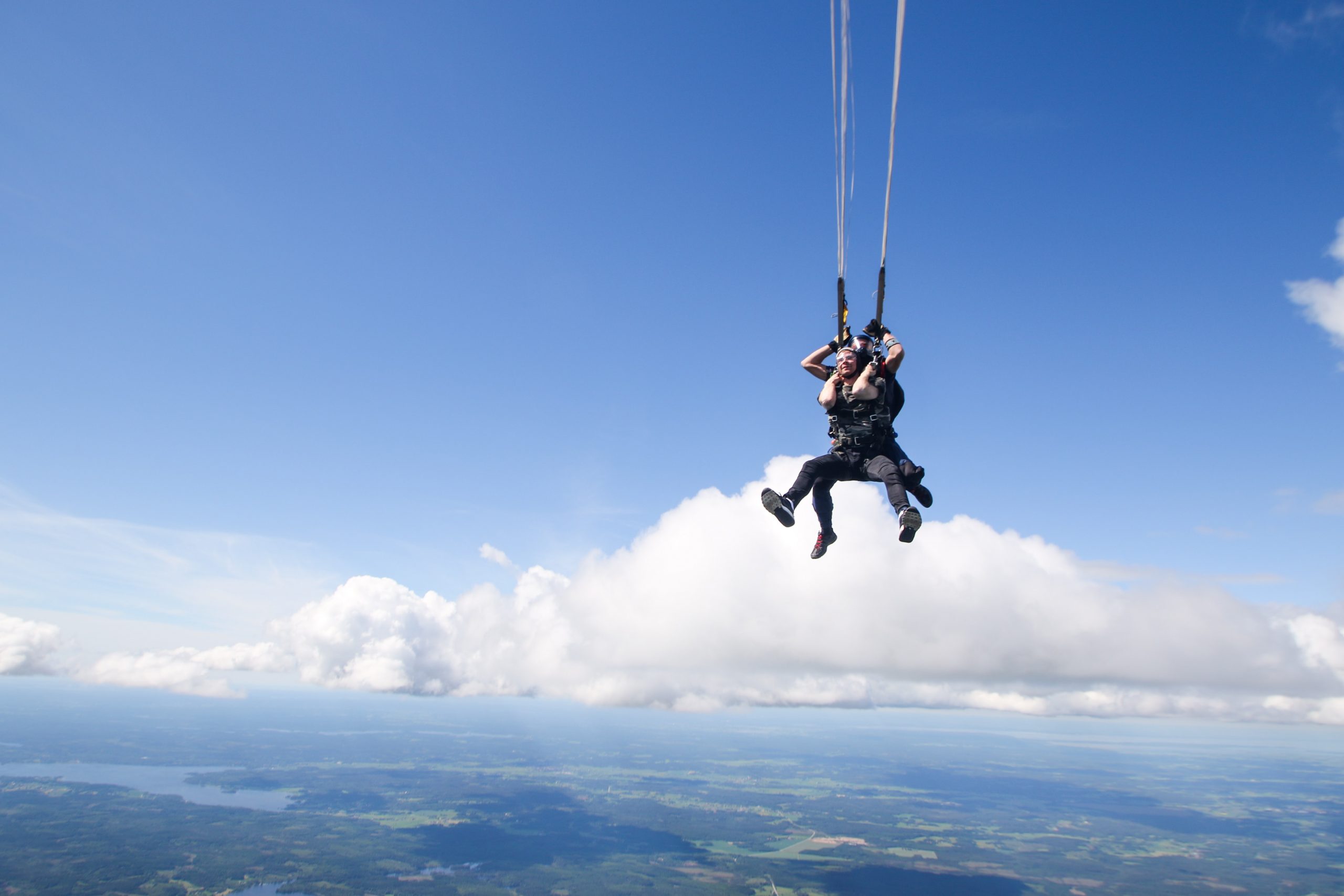 couple parachuting over skyline