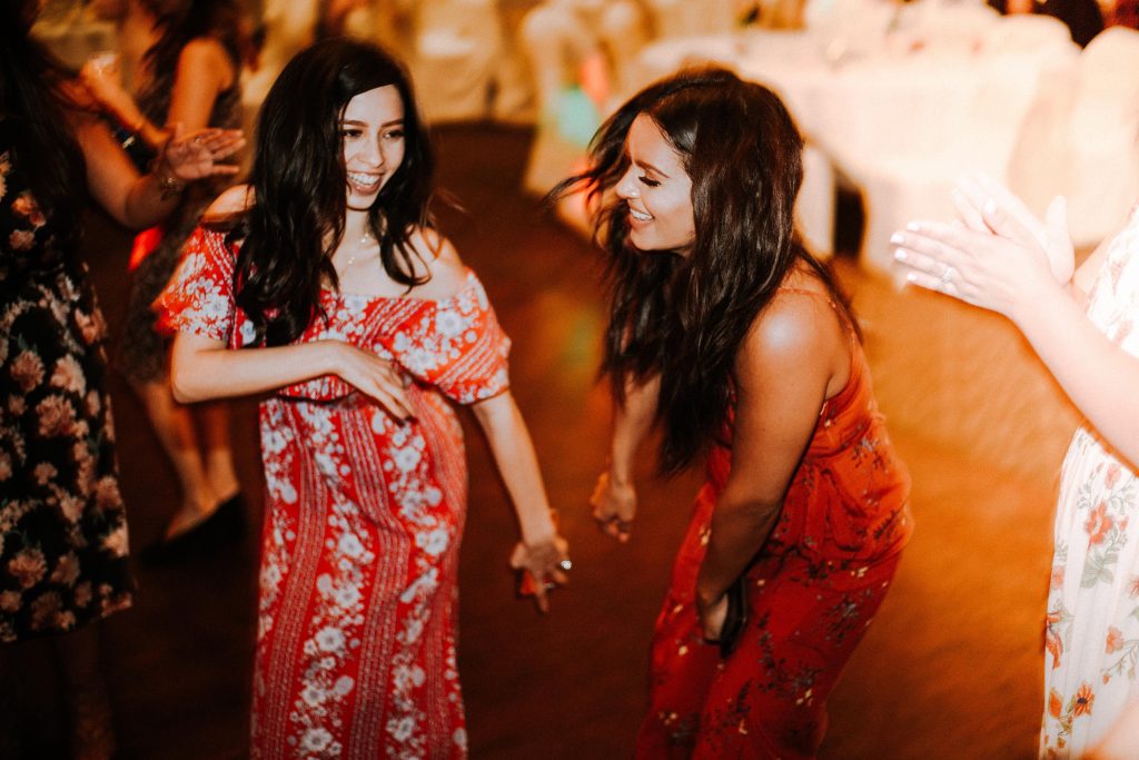 two women dancing at party -- best friend wedding marriage advice friendship