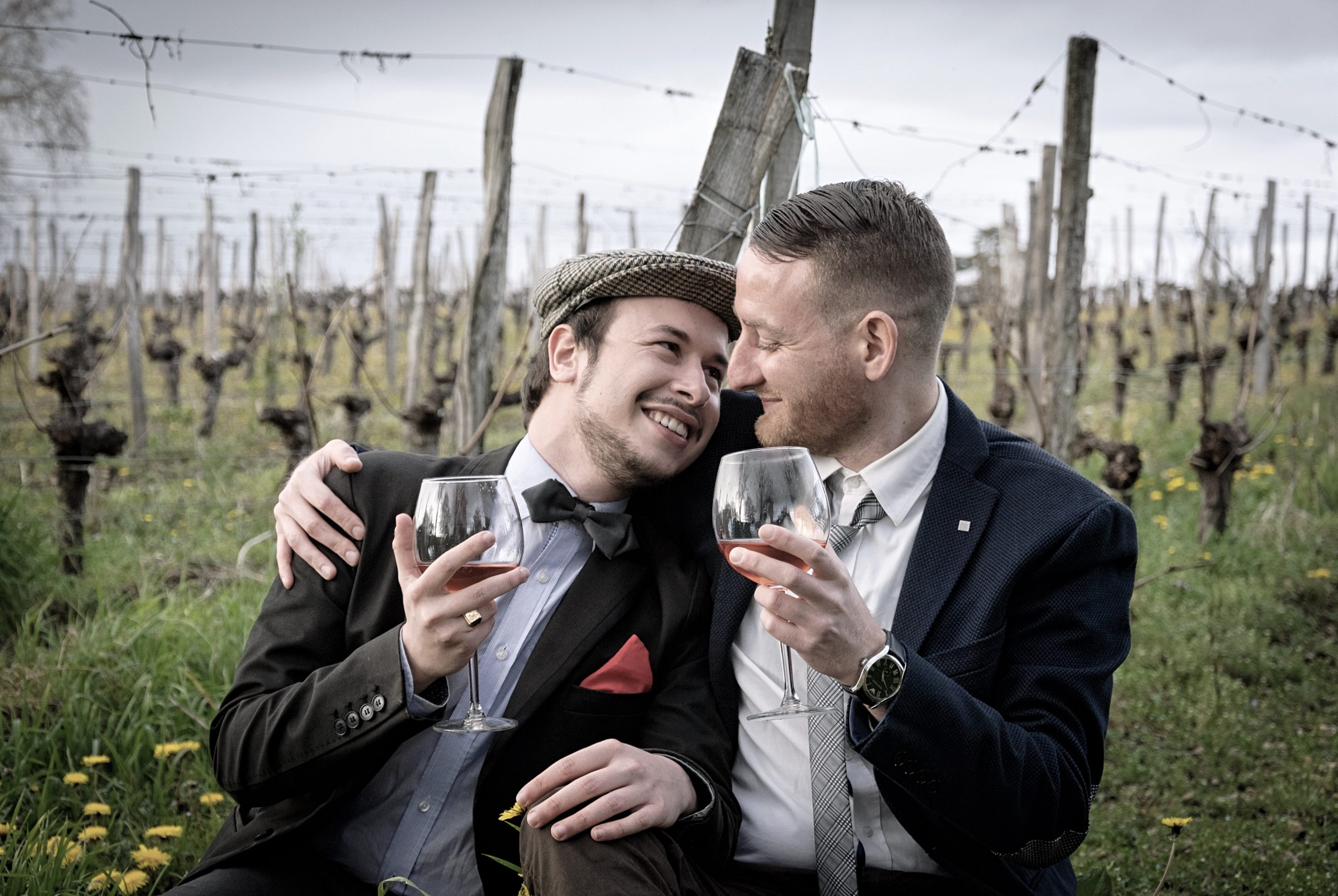couple cuddling and drinking wine in formal wear