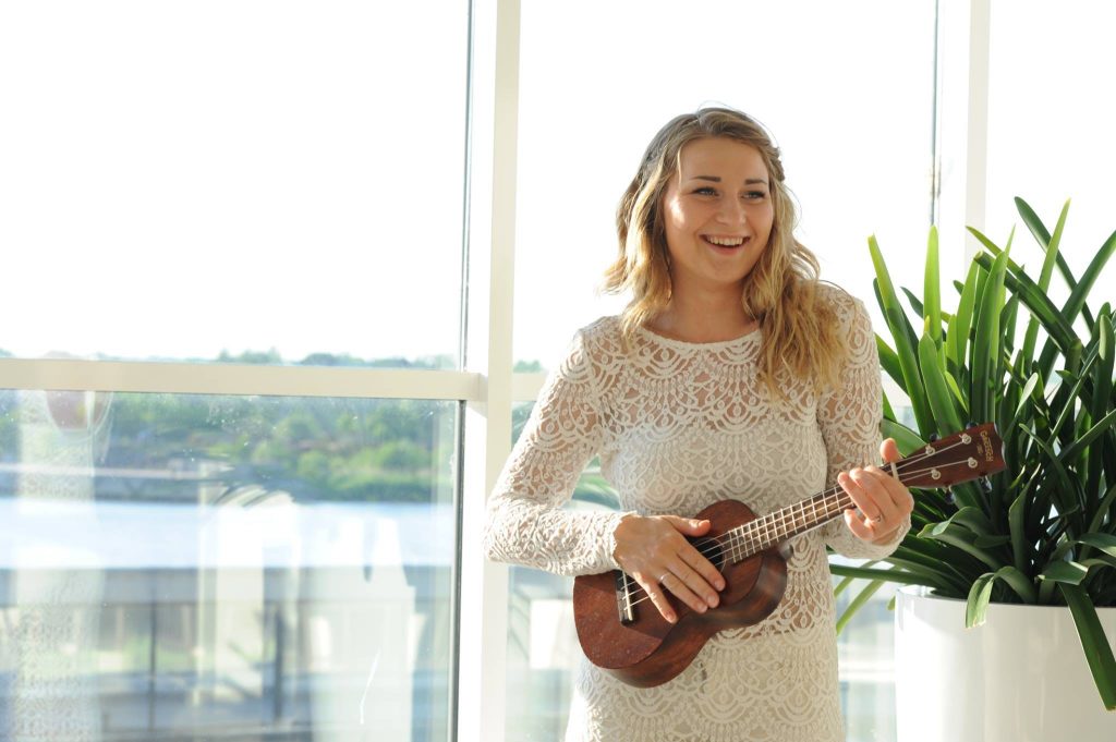 Woman playing a ukulele.