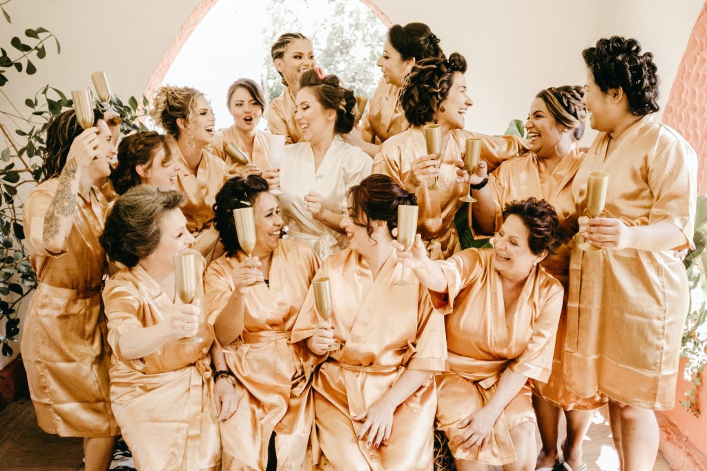 Group of bride and bridesmaids getting ready for wedding.
