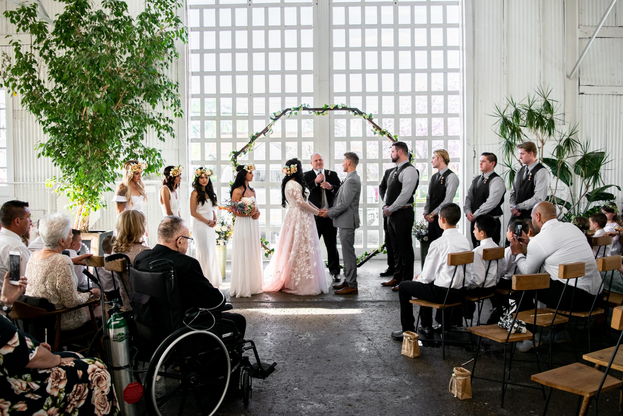 A wedding with a man in a wheelchair at the front of the crowd