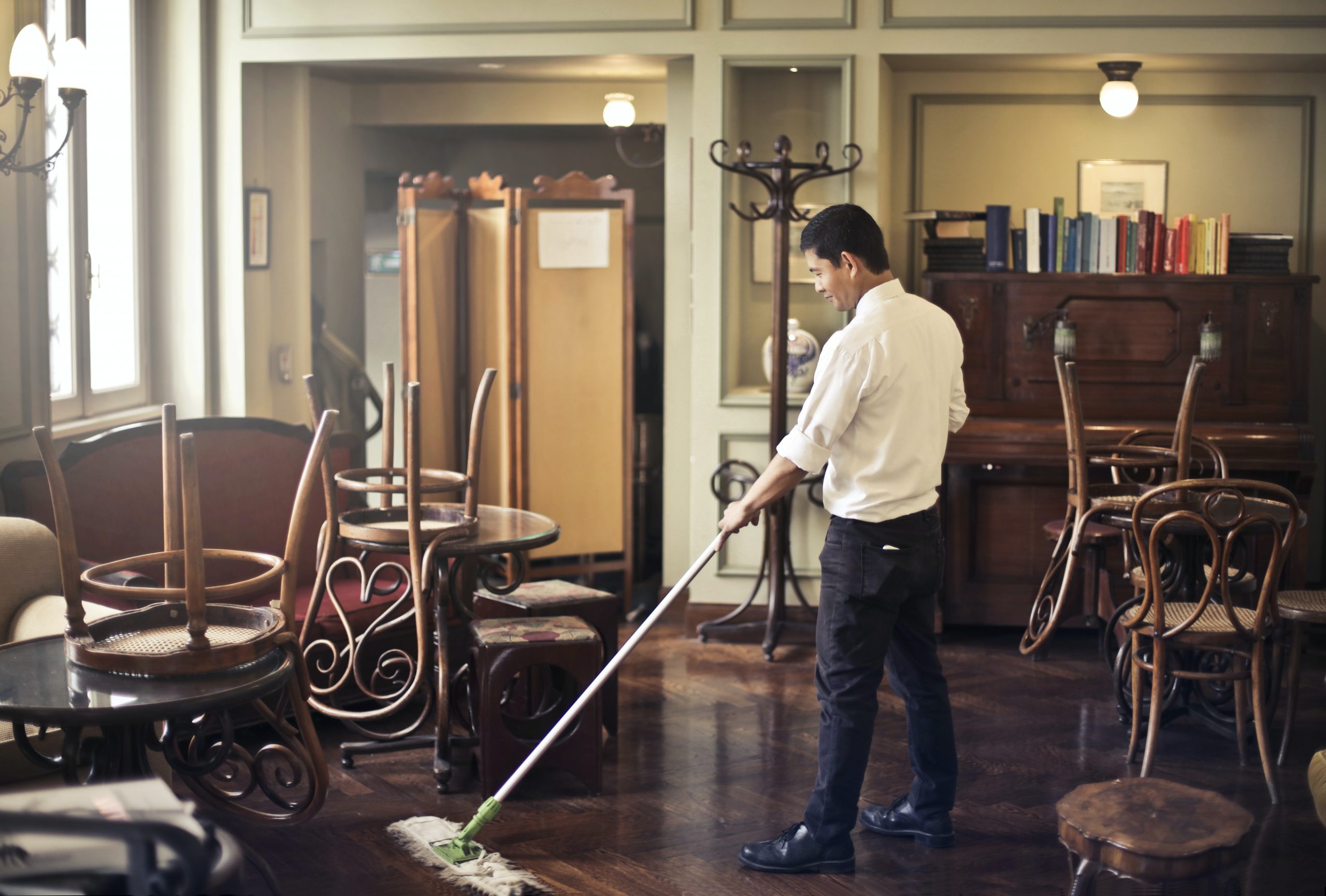 Man mopping floors.