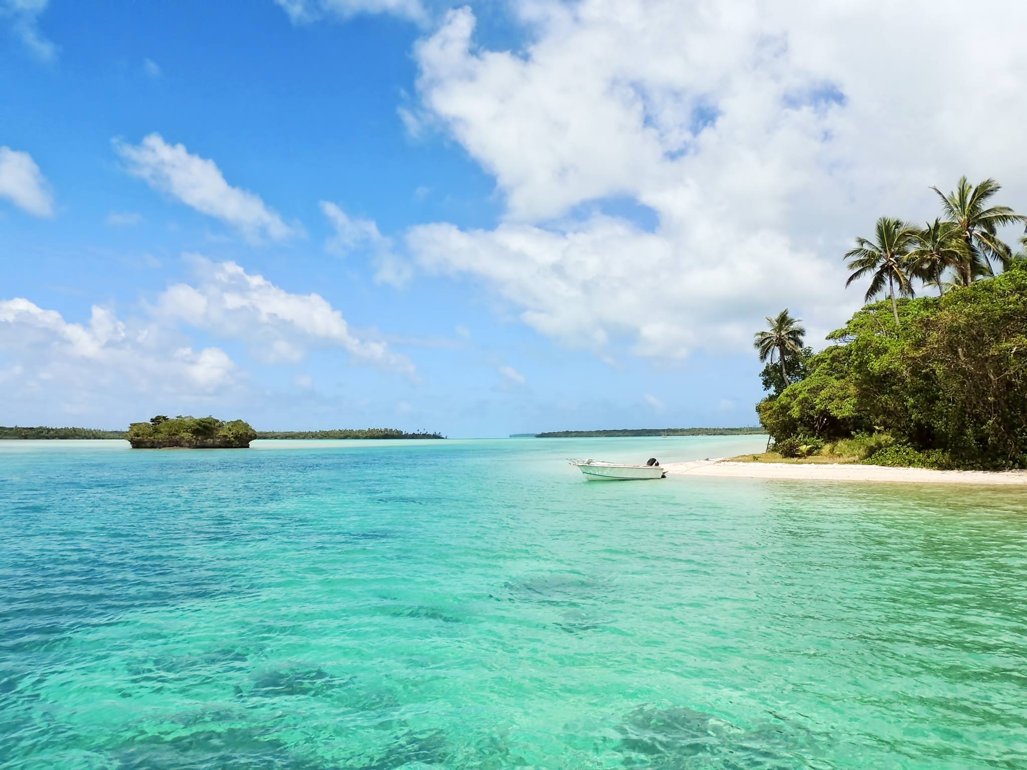 An oean view with clear teal water and an island.