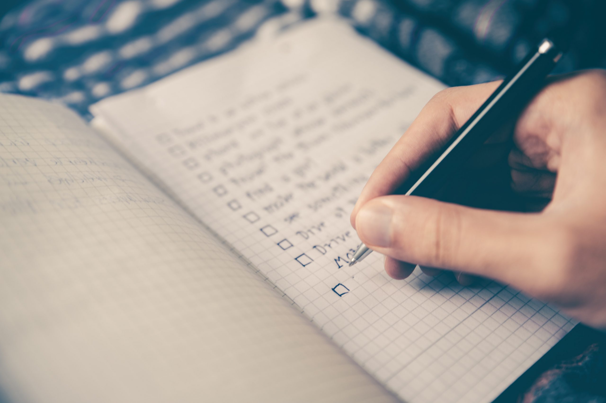 hand writing a to-do list in notebook