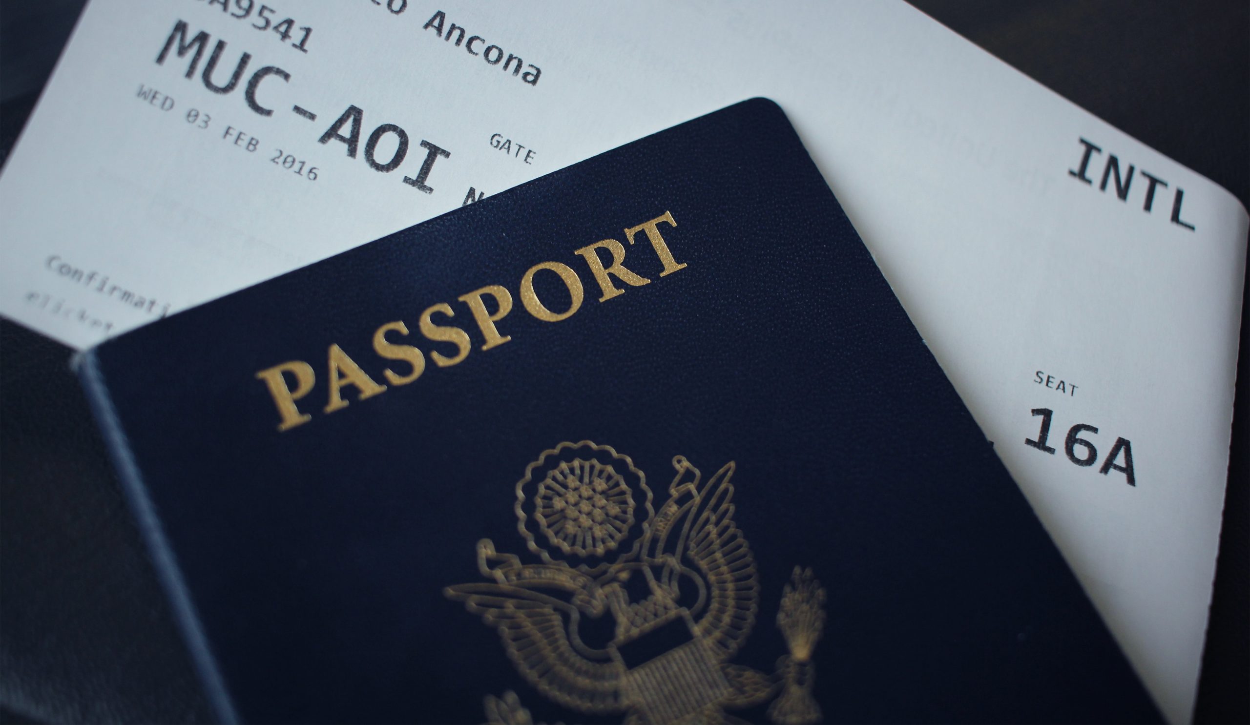 United States passport on top of boarding pass for plane