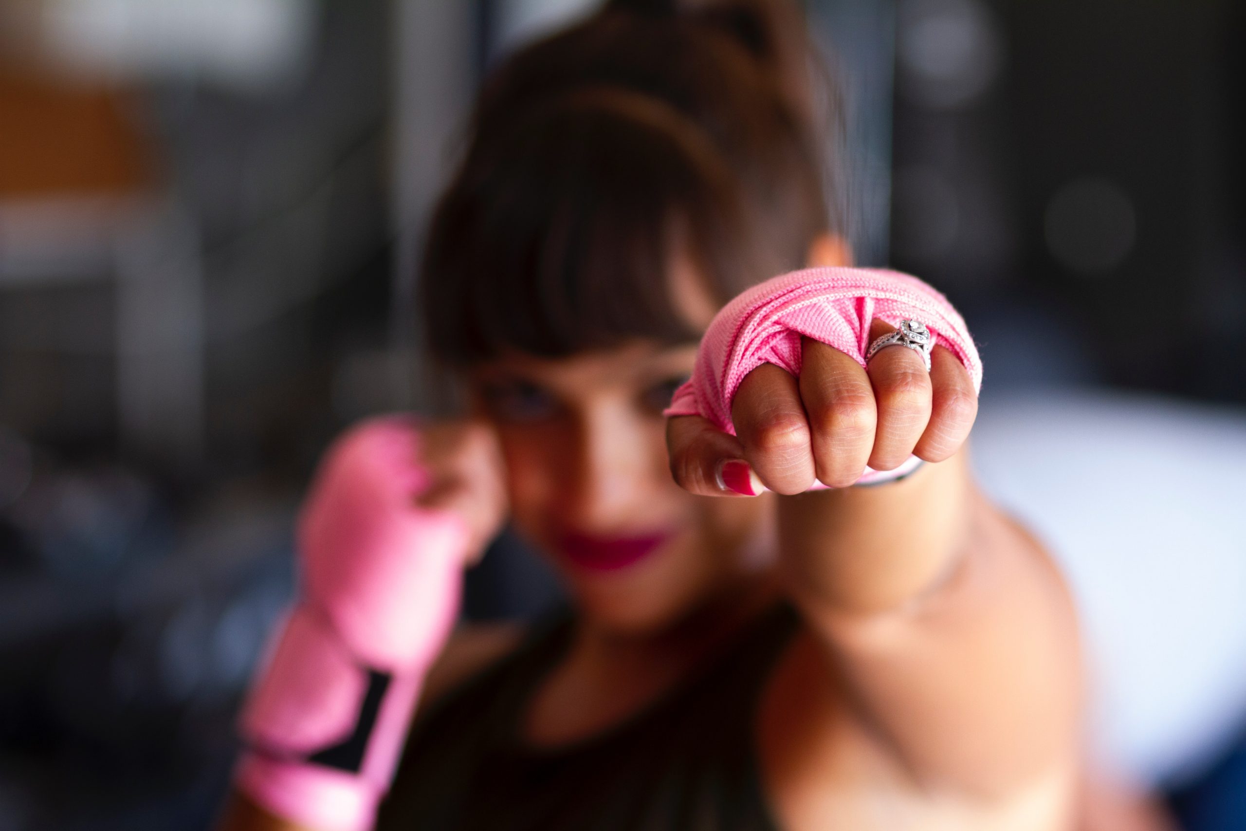 A woman in kickboxing gear with an engagemeent ring